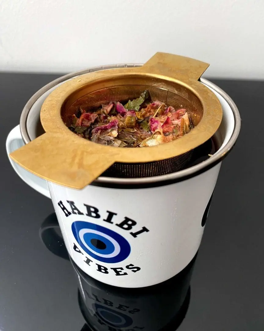 DJ Basbousa enamel mug "habibi vibes" detail.